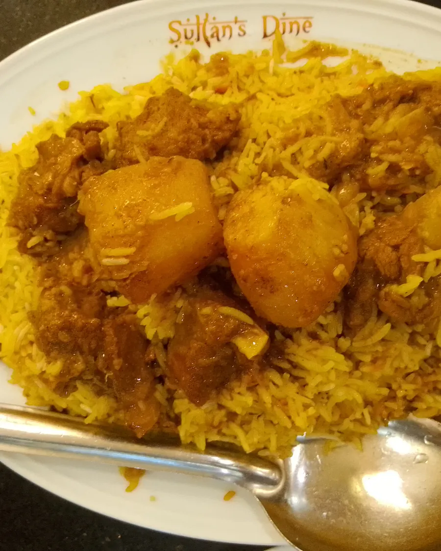 A plate of kacchi biryani with mutton and potato
